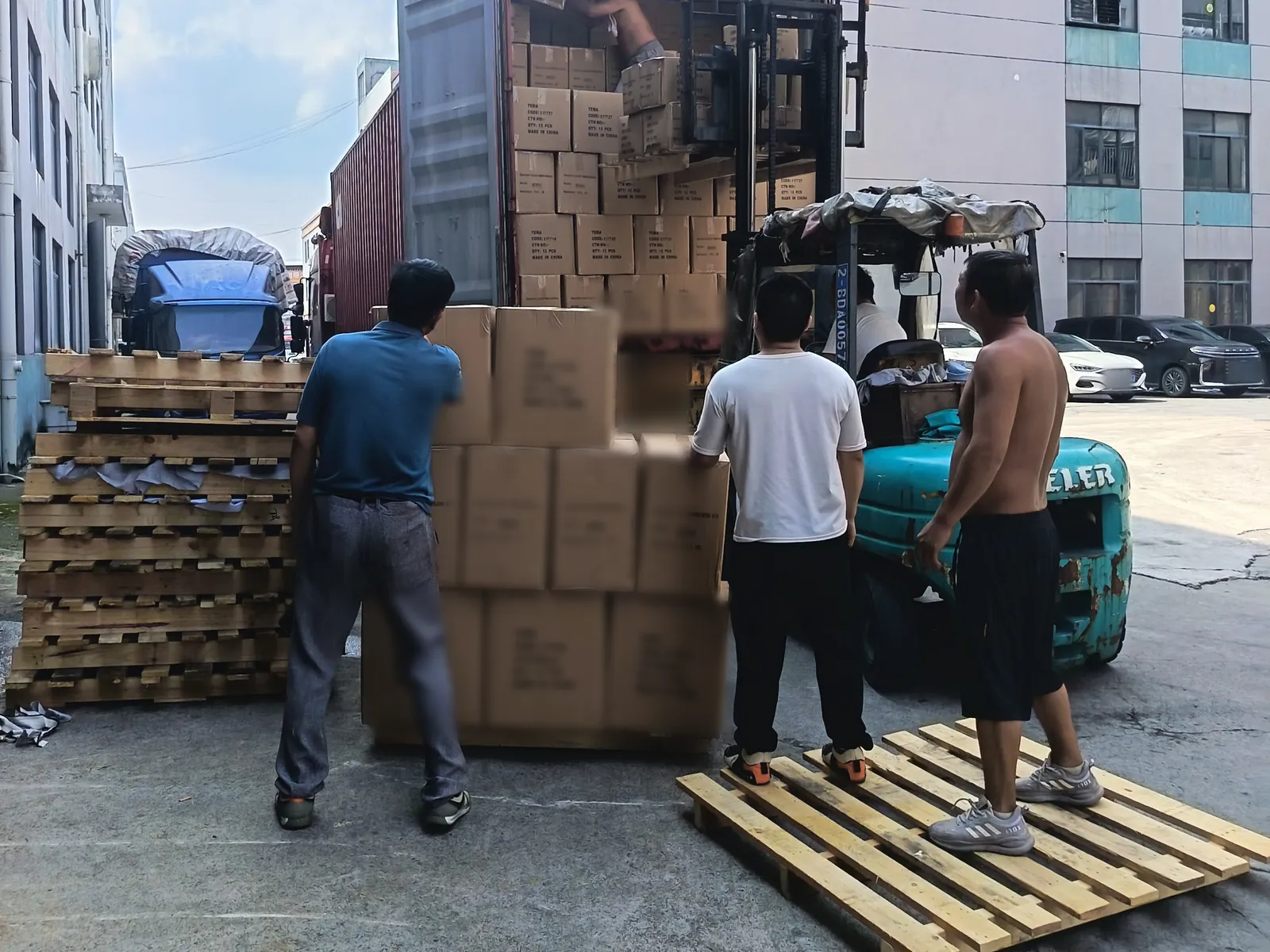 Workers loading curtain cartons into a container at the Xinlan factory
