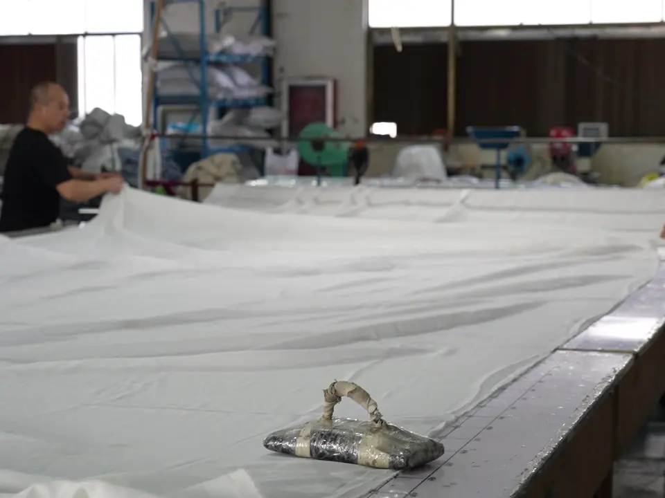 Fabric spread on the cutting table at Xinlan