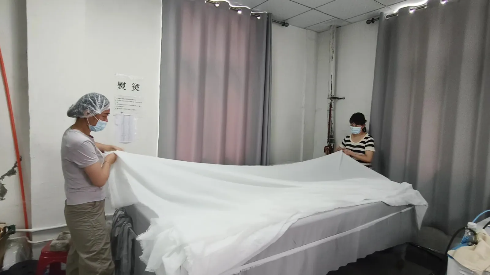 Sheer curtain spread out on an inspection table